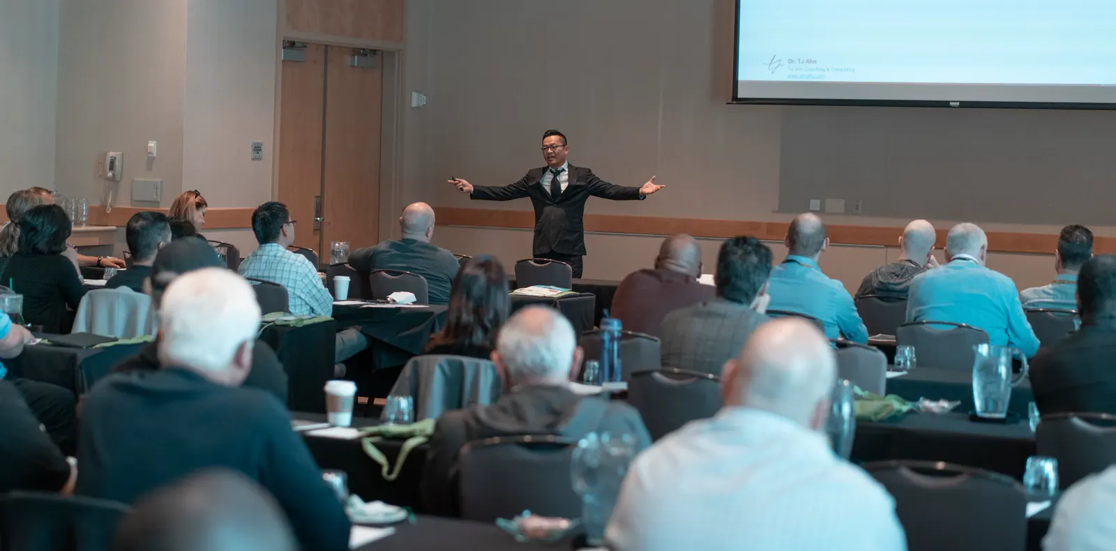 Dr. TJ Ahn teaching a packed room